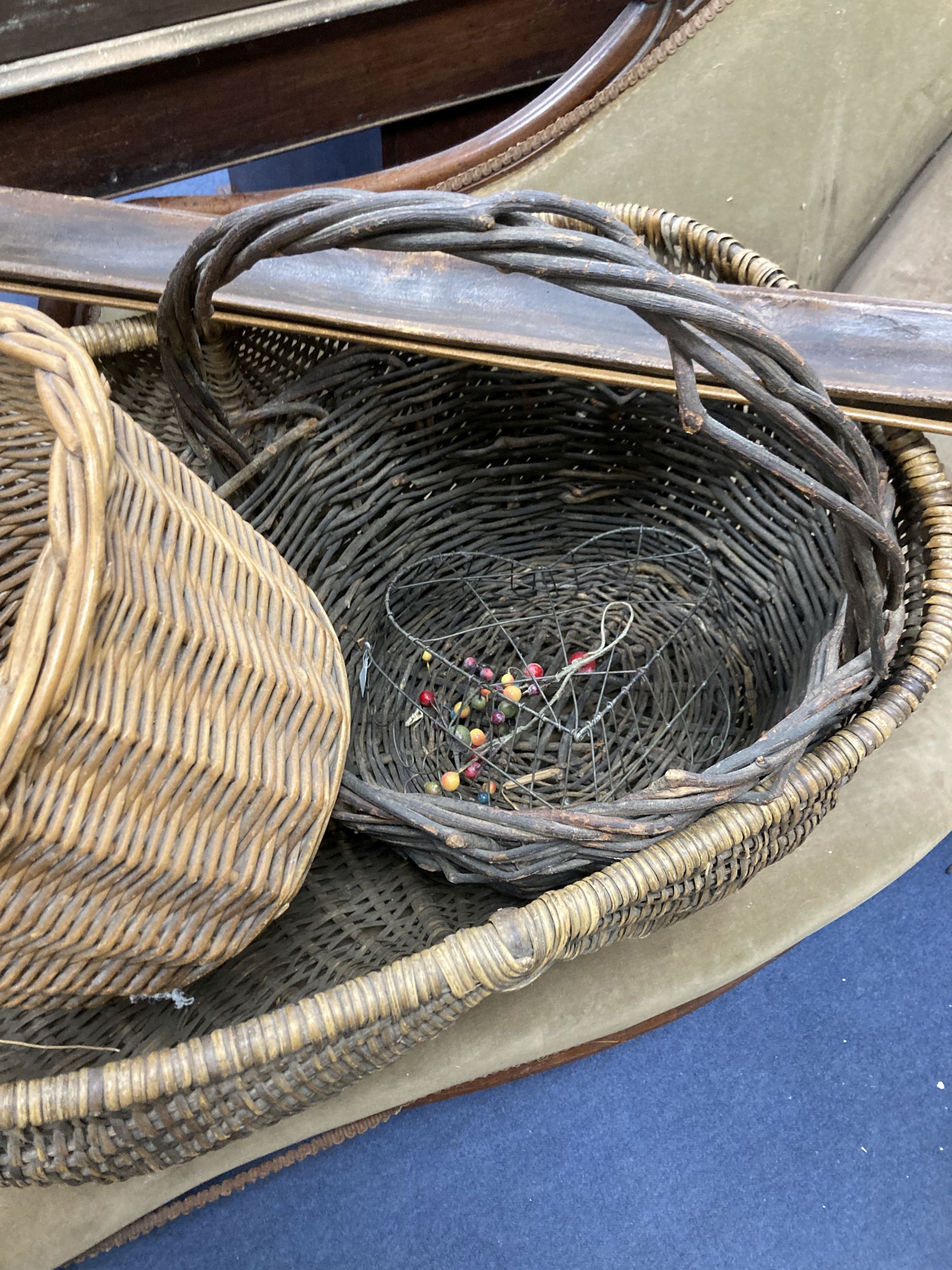 Three wicker baskets, a wirework basket and two baguette stands